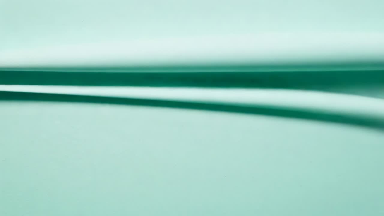 Moving curved darkteal band rising from lower frame, sharpening across macro teal plane, edge line