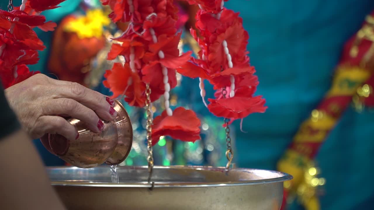 Worshipper Pouring Water Over The Shivling Shiv Ji Murti In Hindu Temple Free Stock Video