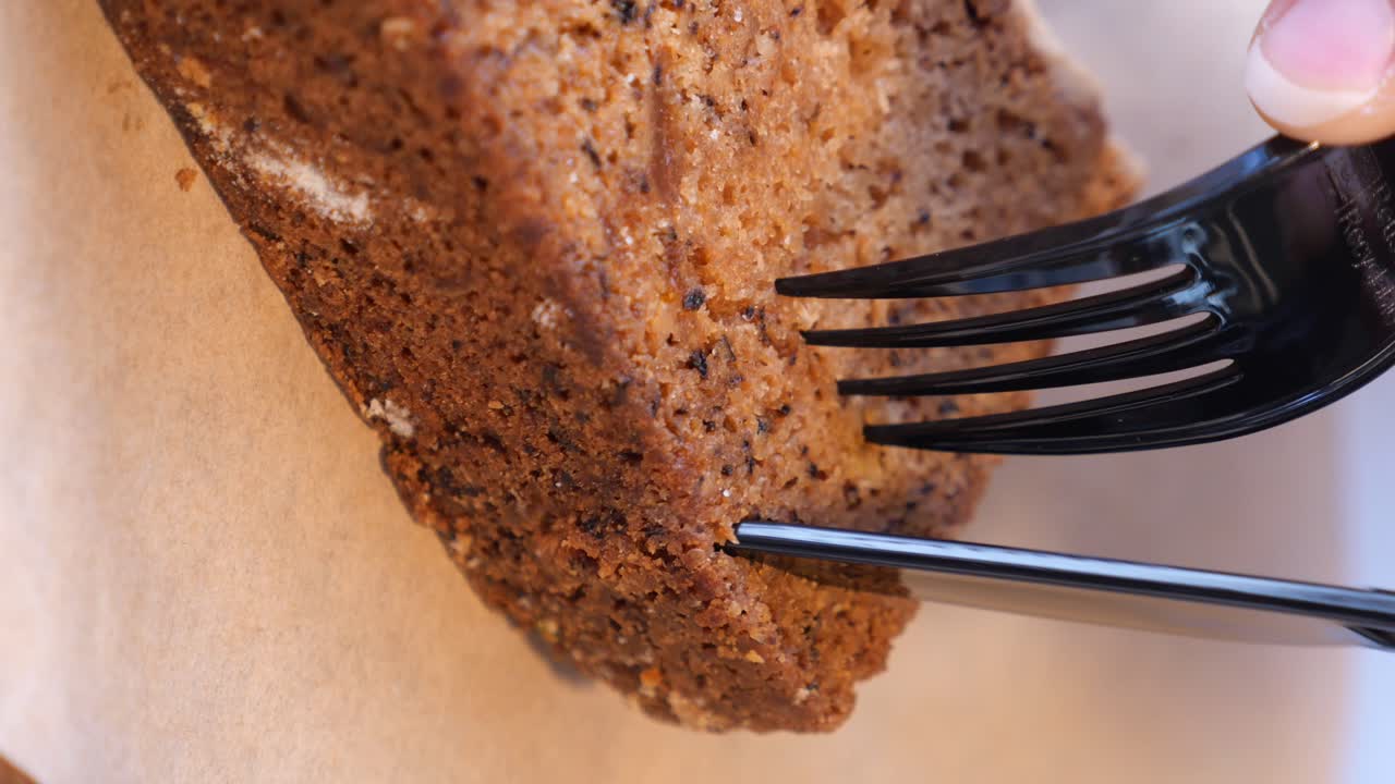 Cake being cut with a fork and knife