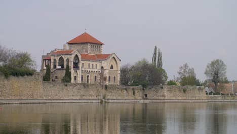 establishing shot of tata castle at the shore of öreg lake, tata, hungary