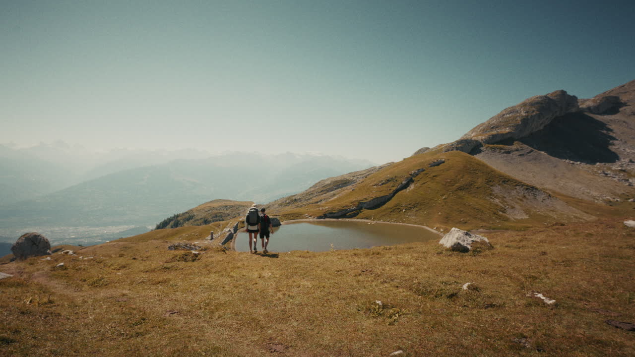 Hikers enjoying a scenic mountain lake view in the Alps