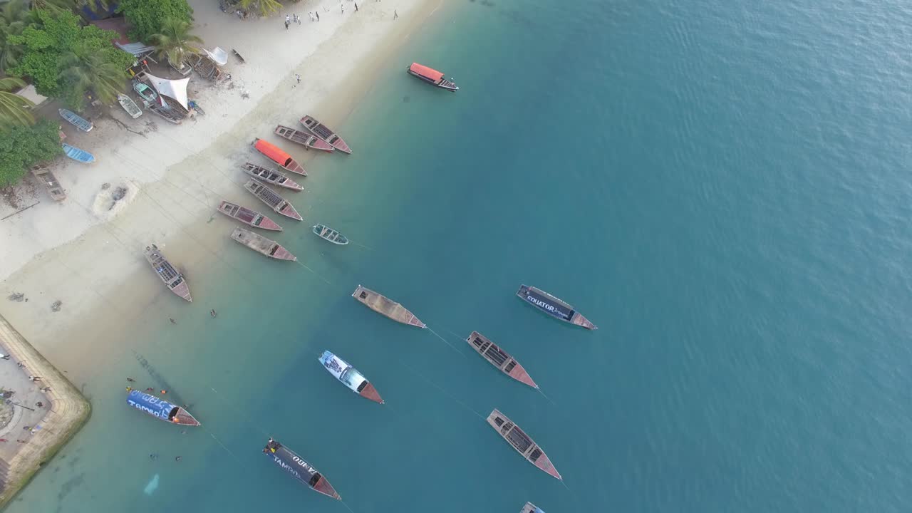 Straight down aerial shot of the beach and boats on the coast of Stone Town in Zanzibar, Tanzania
