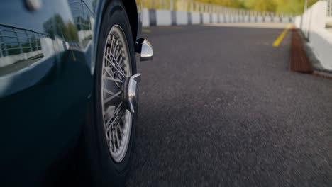 vintage green car on a racing track