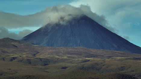 steep cone shape mountain volcano ngauruhoe with clouds