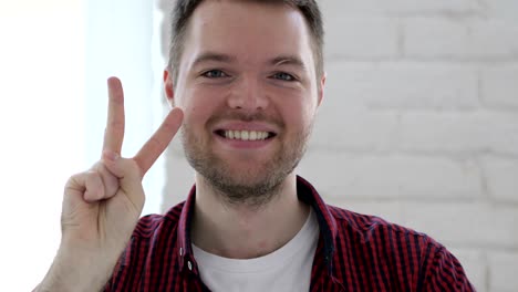 victory sign by successful young man