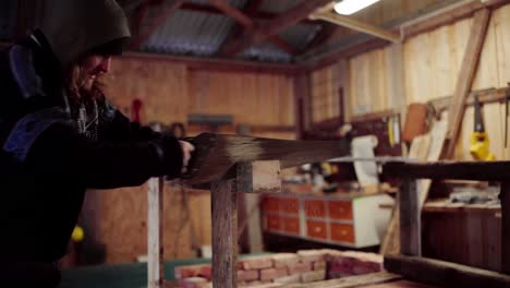 a man is cutting the framework for a homemade hot tub support - static shot