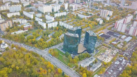 aerial view of a city with modern buildings and autumn foliage
