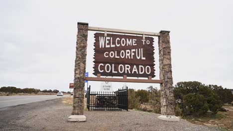 welcome to colorful colorado state line sign on an overcast day, static