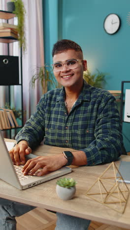 Man-smiling-friendly-at-camera-waving-hands-gesturing-hello-hi-greetings-online-video-call-at-home