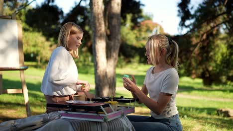 two girls painting outdoors