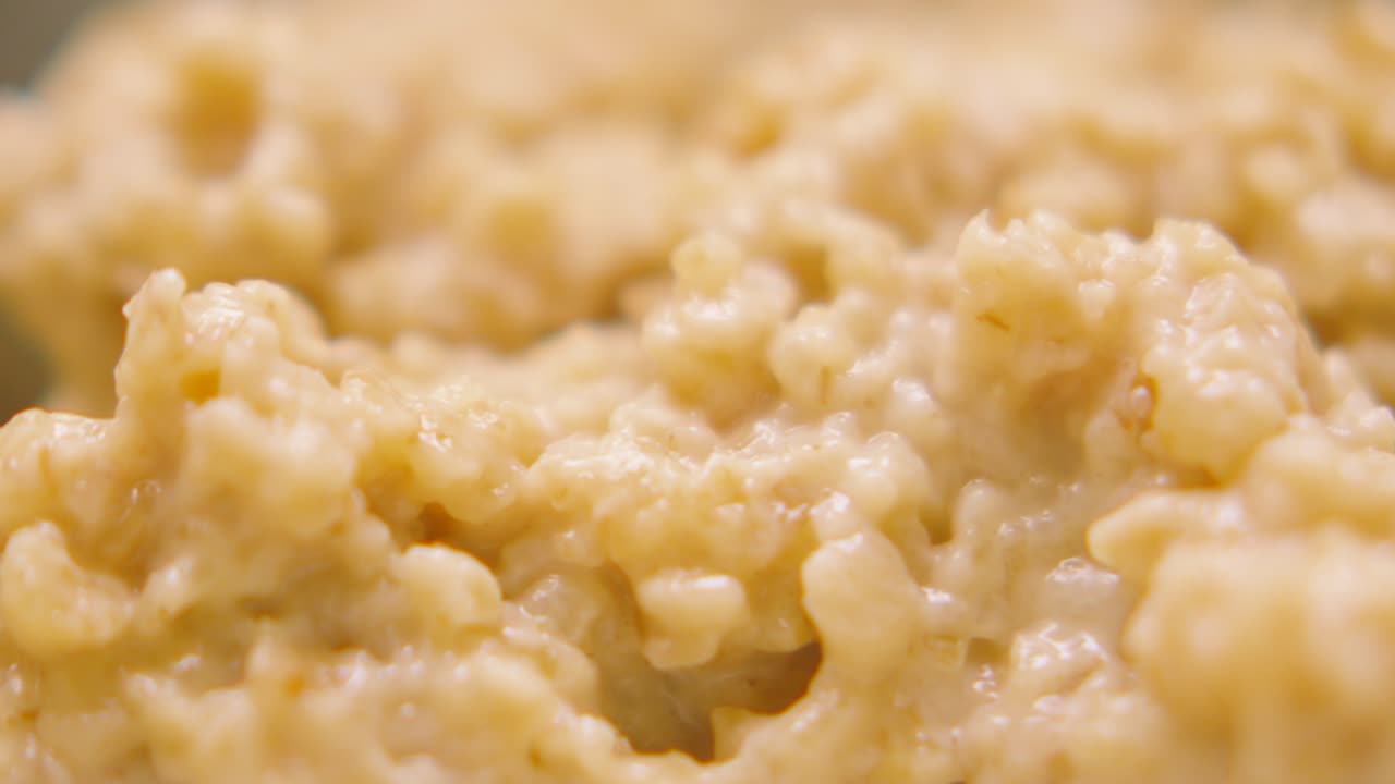 Overview of Cooked Porridge Oats with High Level of Detail. Macro Close Up of Traditional Healthy Breakfast Food