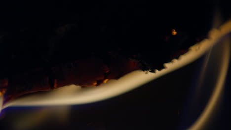 slow motion shot of flames and embers in a fireplace