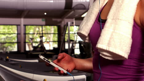 fit woman typing on her smartphone