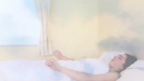 animation of clouds moving over caucasian woman yawning and stretching arms while waking up in bed