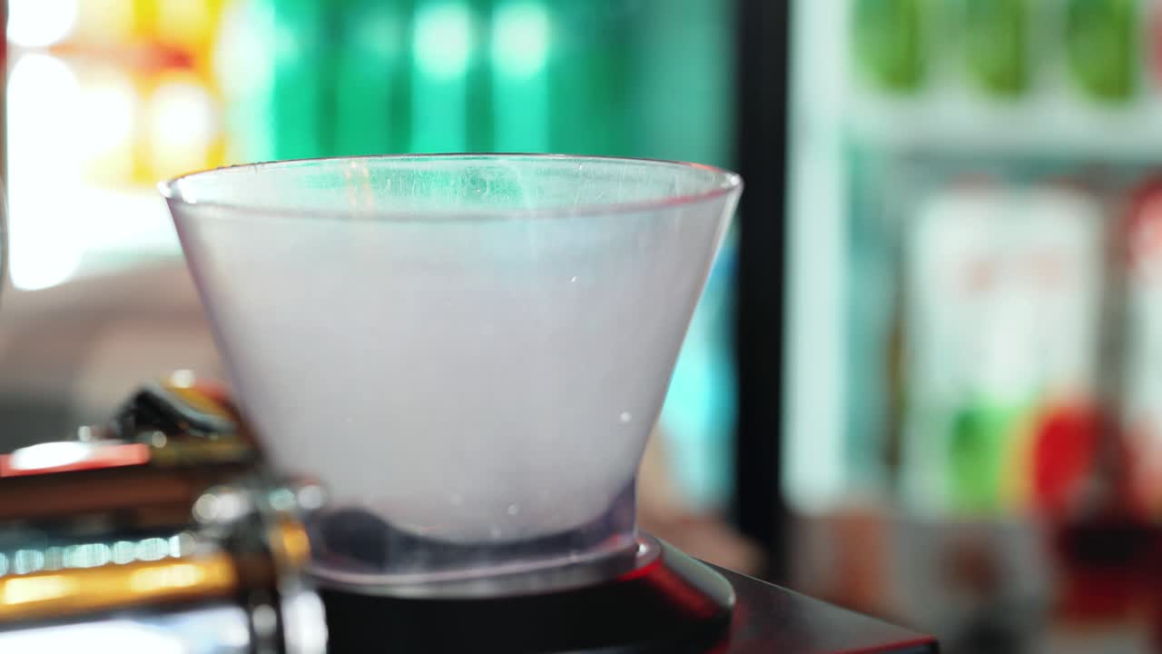 Bartender crushes ice, in the special setting. Bartender preparing cocktail.