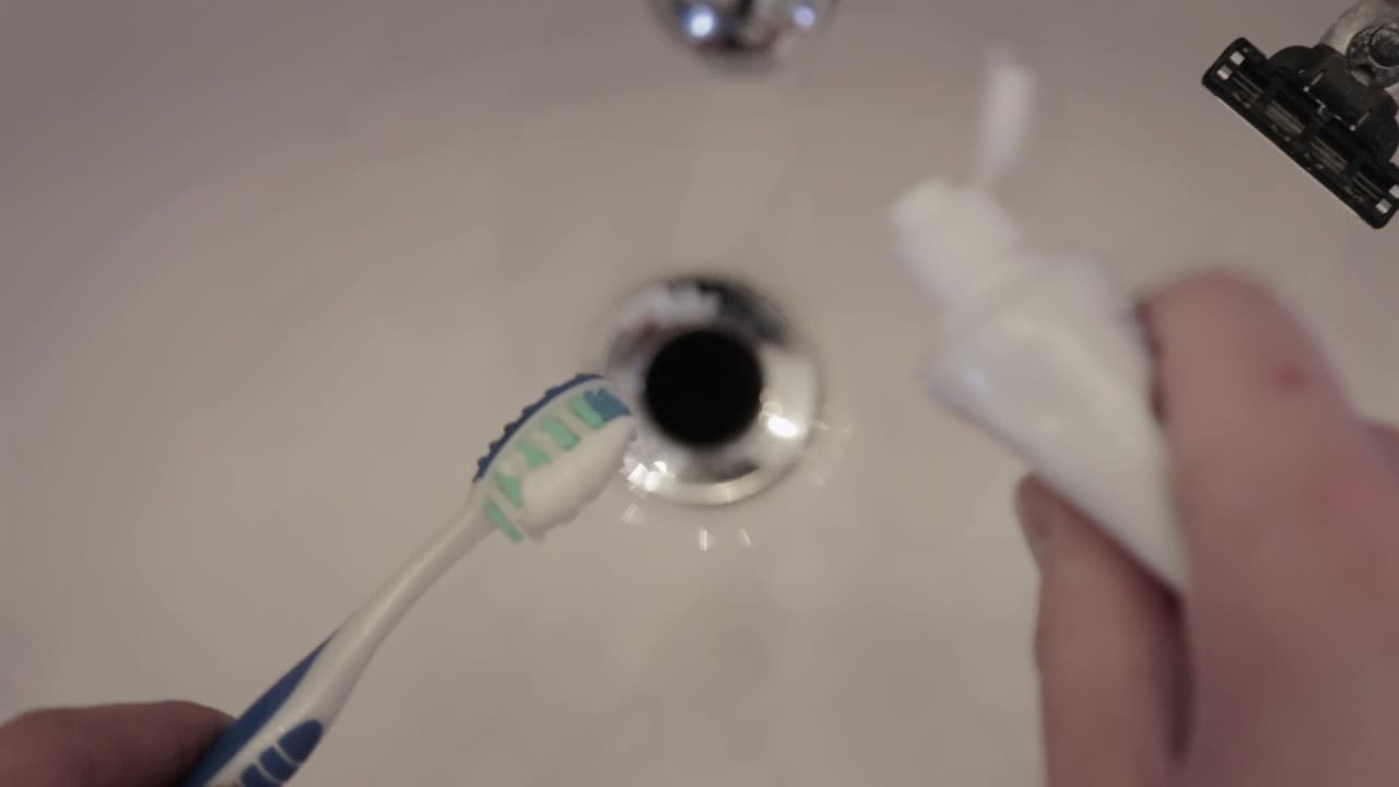 Toothpaste layered on a toothbrush