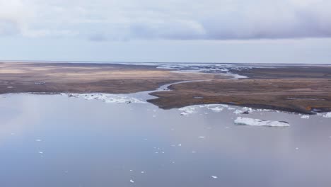 glacial lagoon with calved icebergs floating in water, iceland glacier landscape