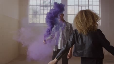 fashionable young man and woman in an abandoned warehouse