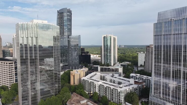 Cinematic drone shot of Atlanta city glass skyscrapers, modern business buildings architectural facade, Georgia, USA