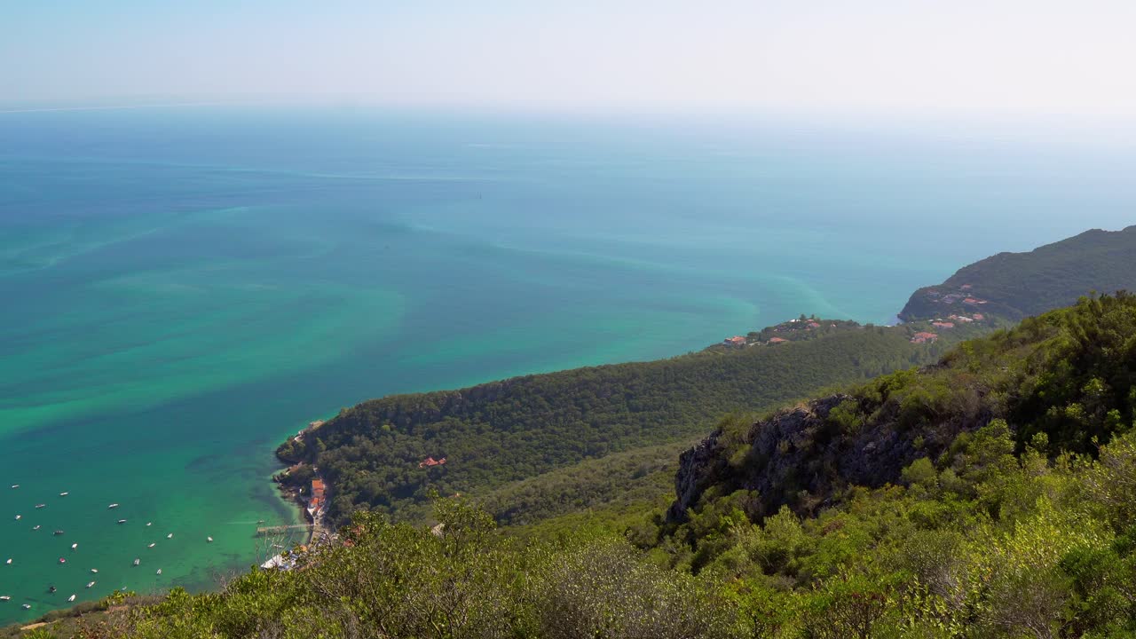 Scenic overlook over the steep hills towards the Atlantic Ocean from Portinho da Arr&aacute;bida, Portugal