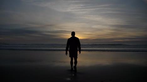 man on beach at sunrise on the coast of california-1