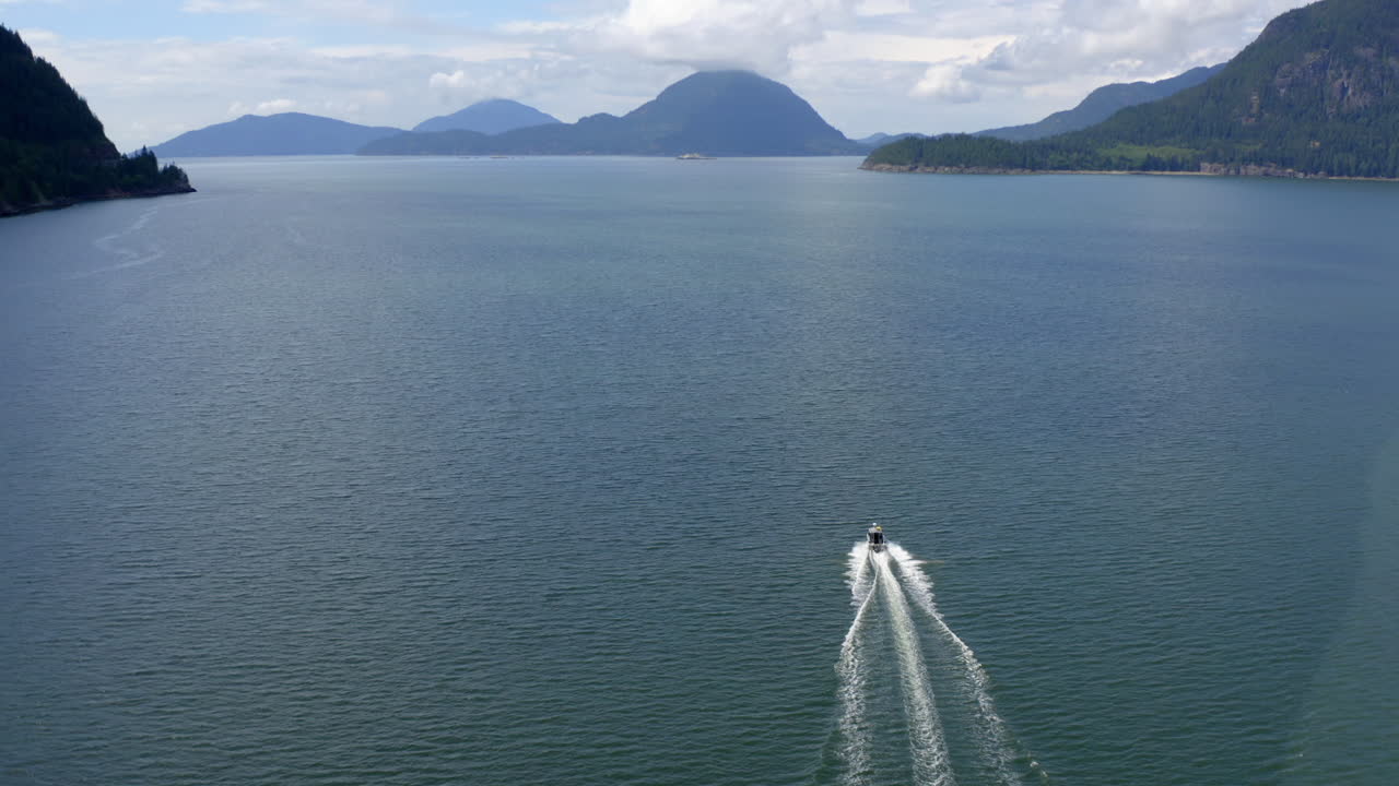 Aerial shot of motorboat on Howe Sound near Porteau Cove on beautiful summer day
