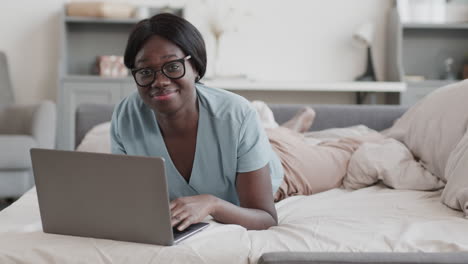 portrait of african-american woman using laptop at home
