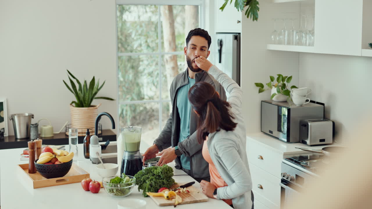 Couple making a healthy smoothie in the kitchen