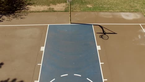 drone footage of scottsdale city park, basketball court fly up to hoop and level off