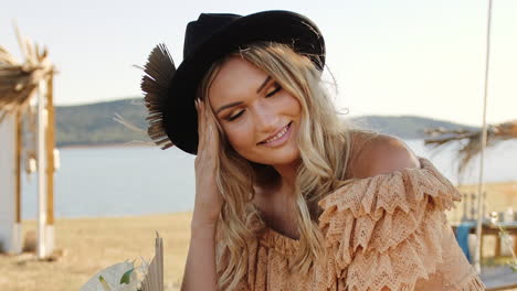 Young-Boho-hippie-woman-posing-and-modelling-at-Wakana-lake-on-summer-day,-in-Cádiz,-Spain---Close-up-push-in-shot