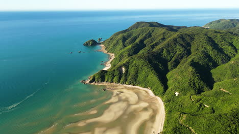 aerial circling deserted beach in abel tasman national park, new zealand