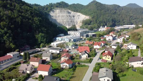 Top,-drone-view-of-small-town,-human-settlement,-surrounded-by-forests