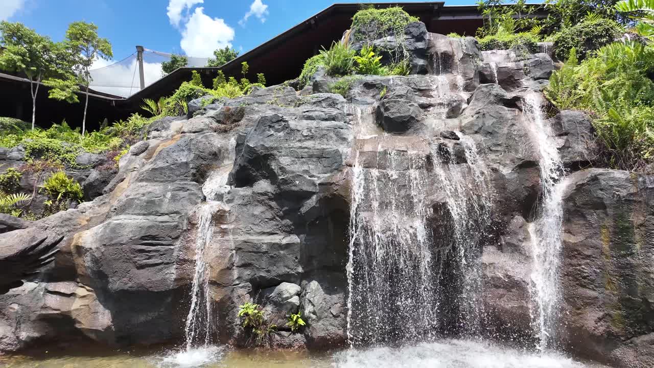 Waterfall cascading over rocks with lush vegetation