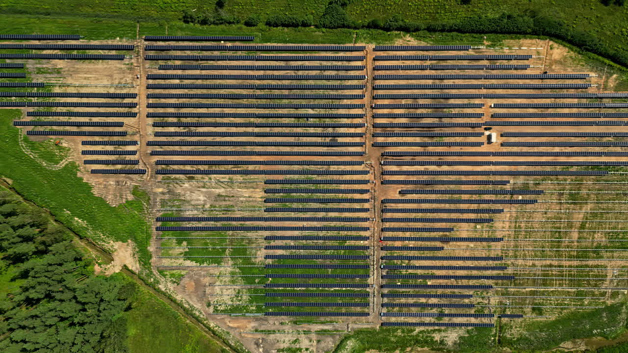 Rows of newly constructed solar panel field and farm for clean, renewable energy