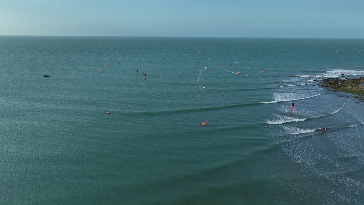 Many Windsurfers and Surfers Surfing on the Ocean - Aerial View