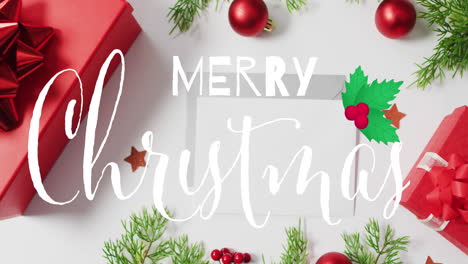 animación del texto de feliz navidad sobre decoraciones y sobres de navidad