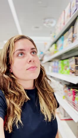 thoughtful woman in a brightly lit store aisle