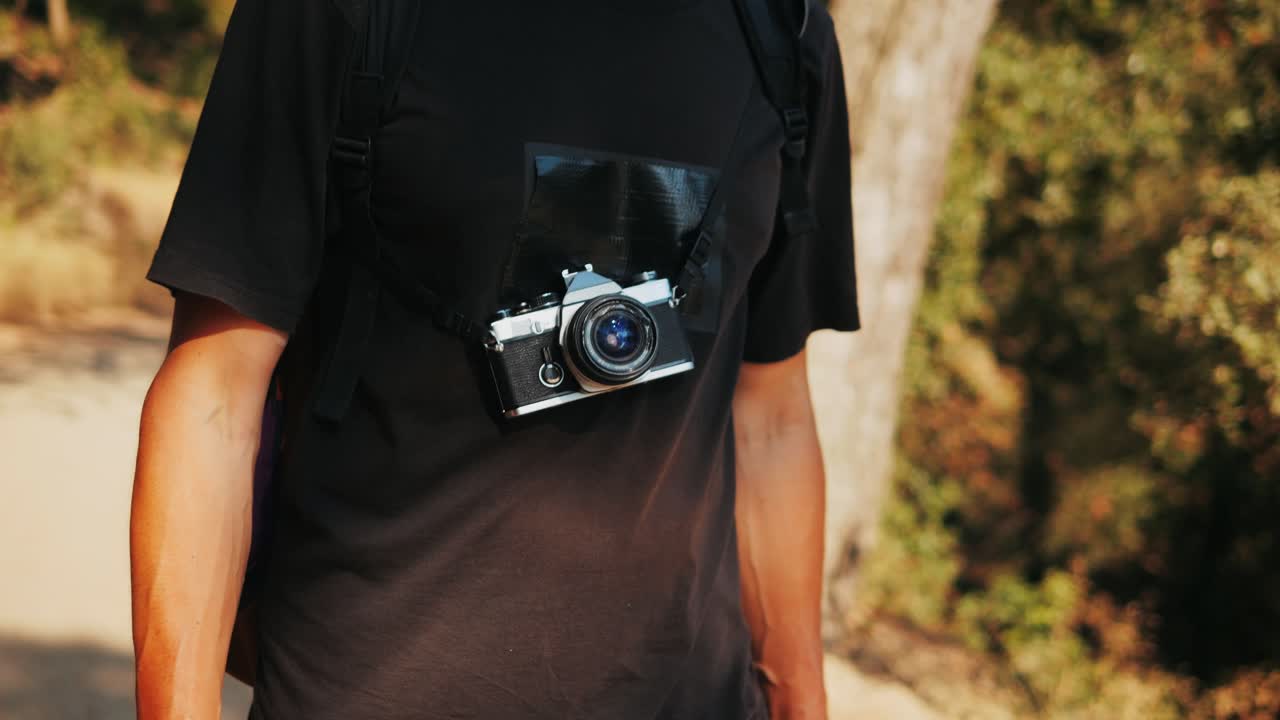 Man with a vintage camera on his chest