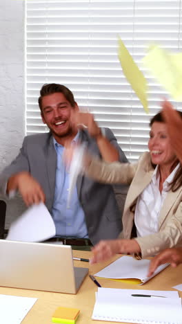 casual business team throwing papers in the air