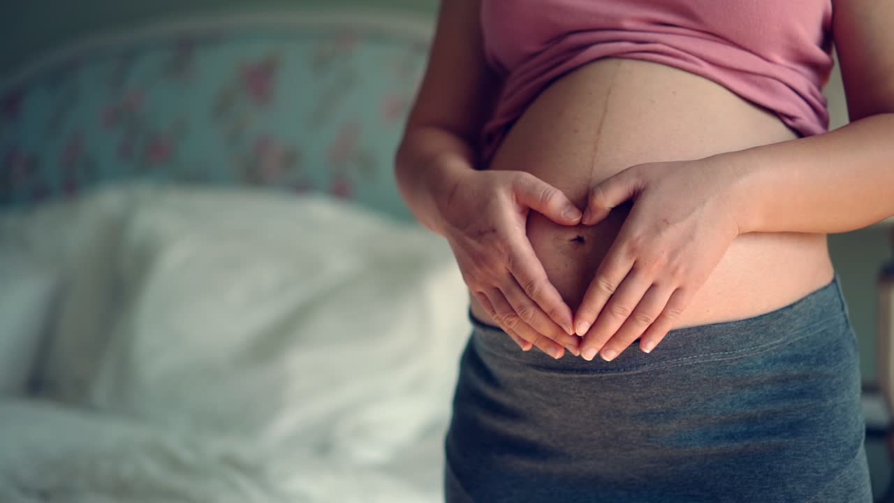 Happy pregnant woman and expecting baby at home.