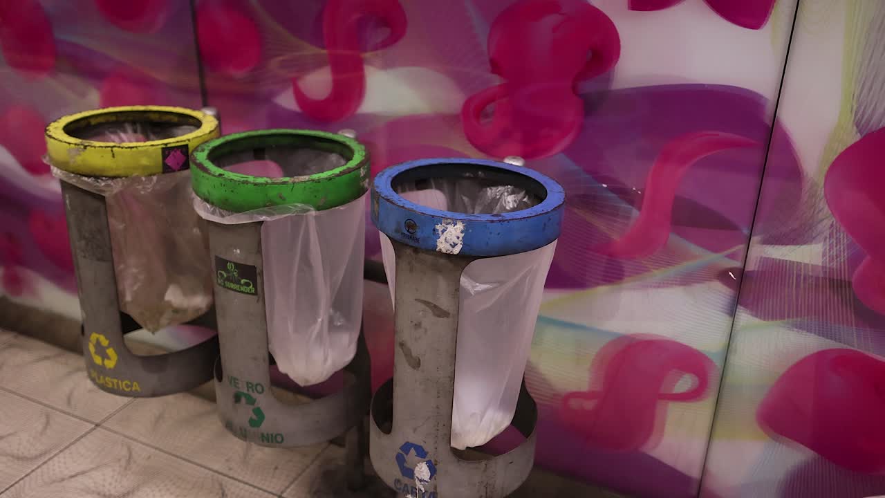 Garbage bins in a colorful subway station