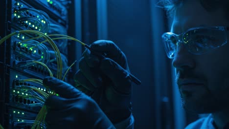focused technician working with fiber optic cables in a dark server room, ensuring optimal connectivity and data flow with precise tooling techniques