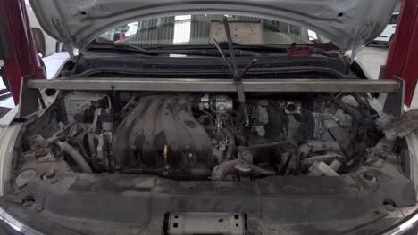 the front of a car with the hood up showing the motor engine for repair service at a workshop station garage at mexico latin-america