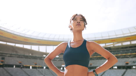 motivated woman in sports bra in stadium