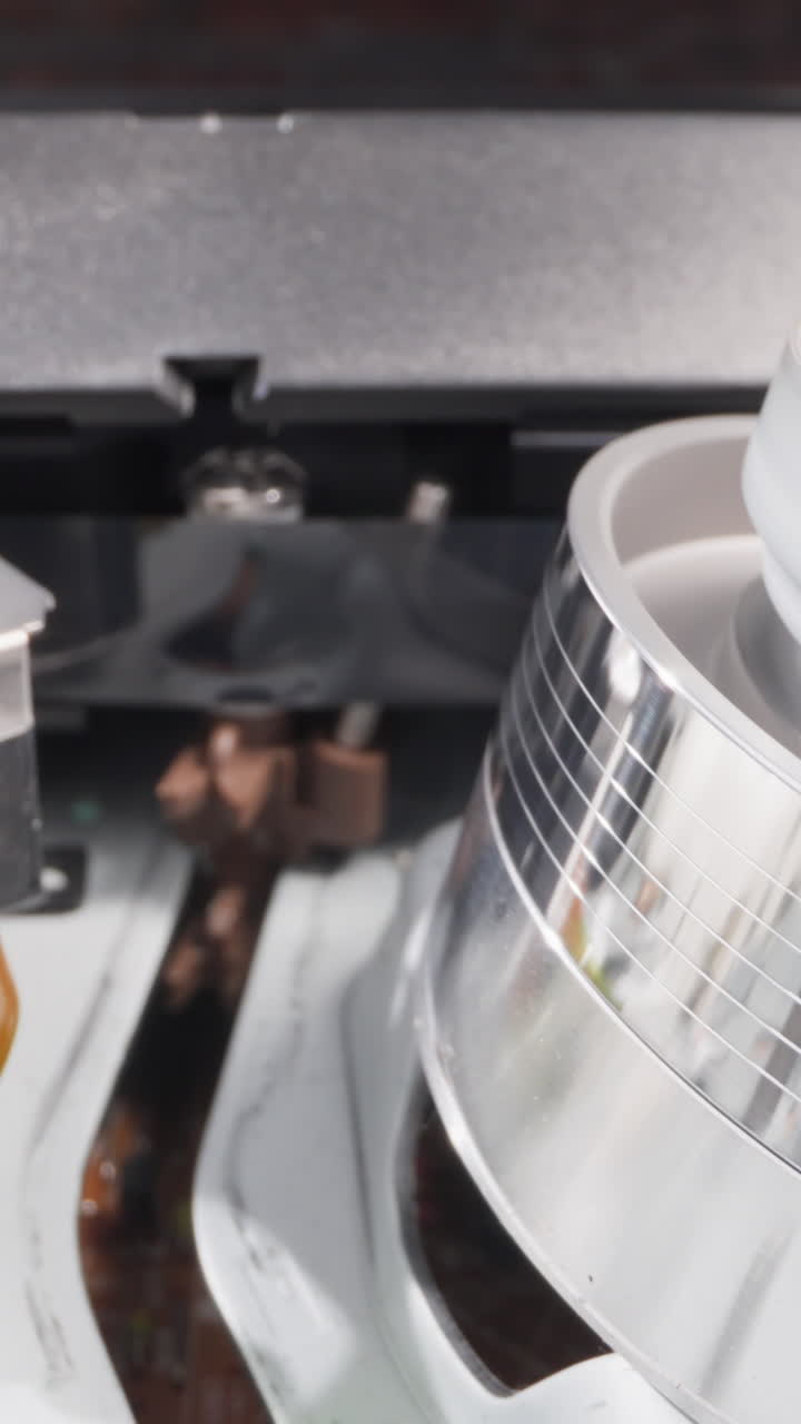 Cassette recorder unit moves tape to shiny spinning head to play video extreme closeup. Vintage equipment repairing service. Old appliance mechanism checkup