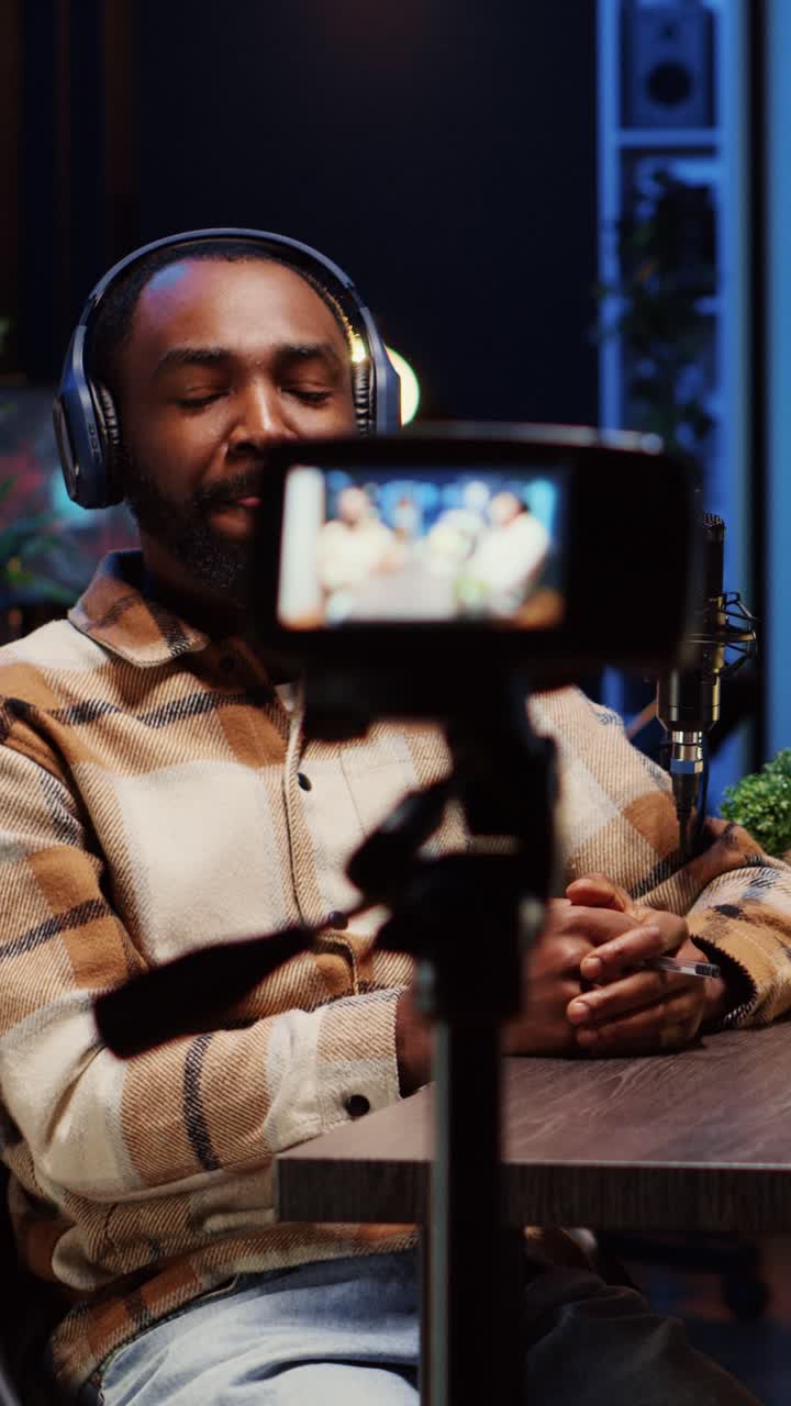 Vertical video Influencer using professional camera to record podcast with guest, talking and having fun