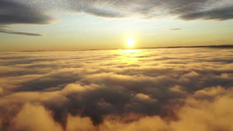 Drone-shot-above-the-clouds-showing-the-sun-and-clouds