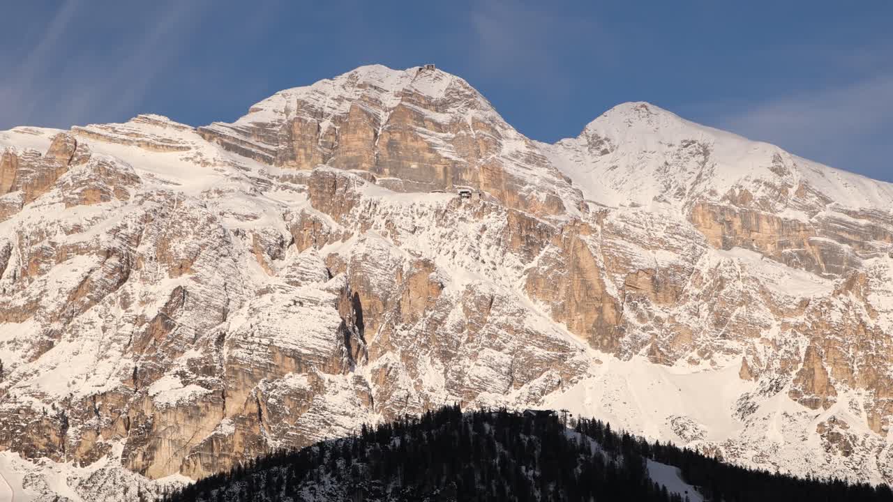 Breathtaking wide-angle panoramic view of the jagged, snow-covered mountain peaks of the Dolomites near Cortina d'Ampezzo in the Italian Alps
