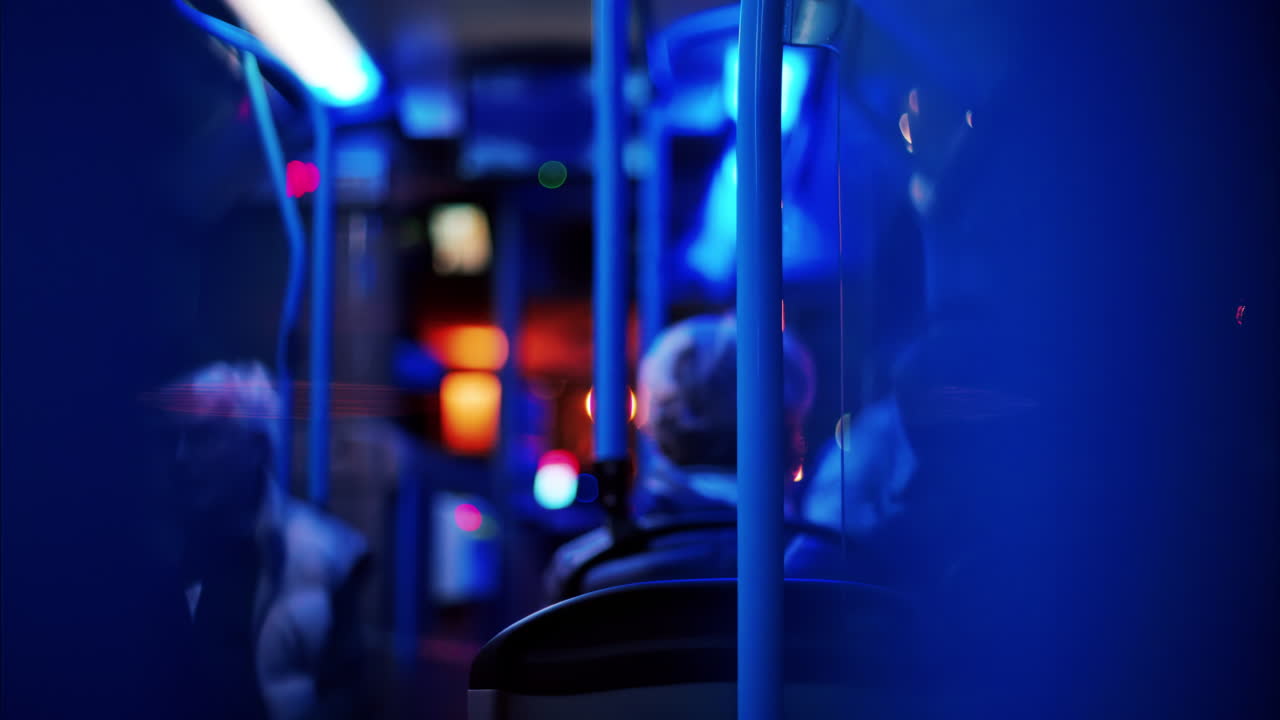 People sitting in a moving train in the evening with blue lighting
