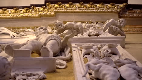 stuccoes and statues inside the serpotta chapel of castelbuono castle, sicily. angels, devils, and fierce demonic faces decorate this masterpiece, showcasing baroque artistry at its finest.